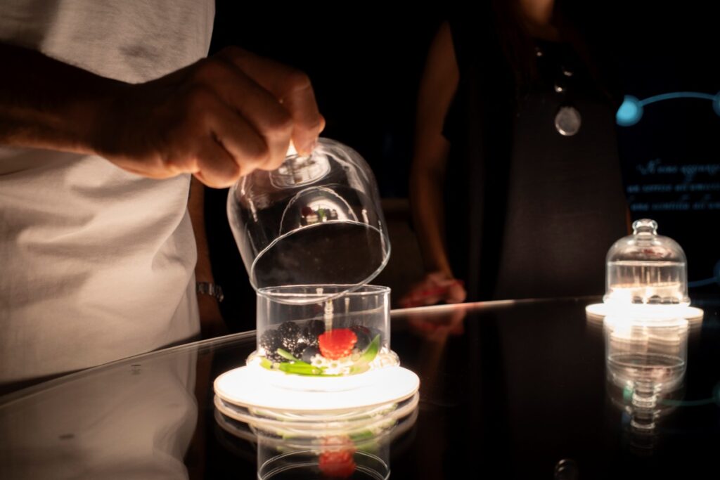 Close-up of guest smelling wine, capturing the aromas of ripe fruits and fresh nature.