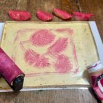 Leaf impressions on a magenta gel plate after removing leaves in a printmaking workshop for kids Florence
