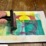 Completing a multicolor monoprint with a brayer at an art class for children Florence, Fatacadabra