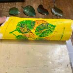 Peeling a finished yellow leaf print from the plate at a monoprint workshop Florence, Fatacadabra