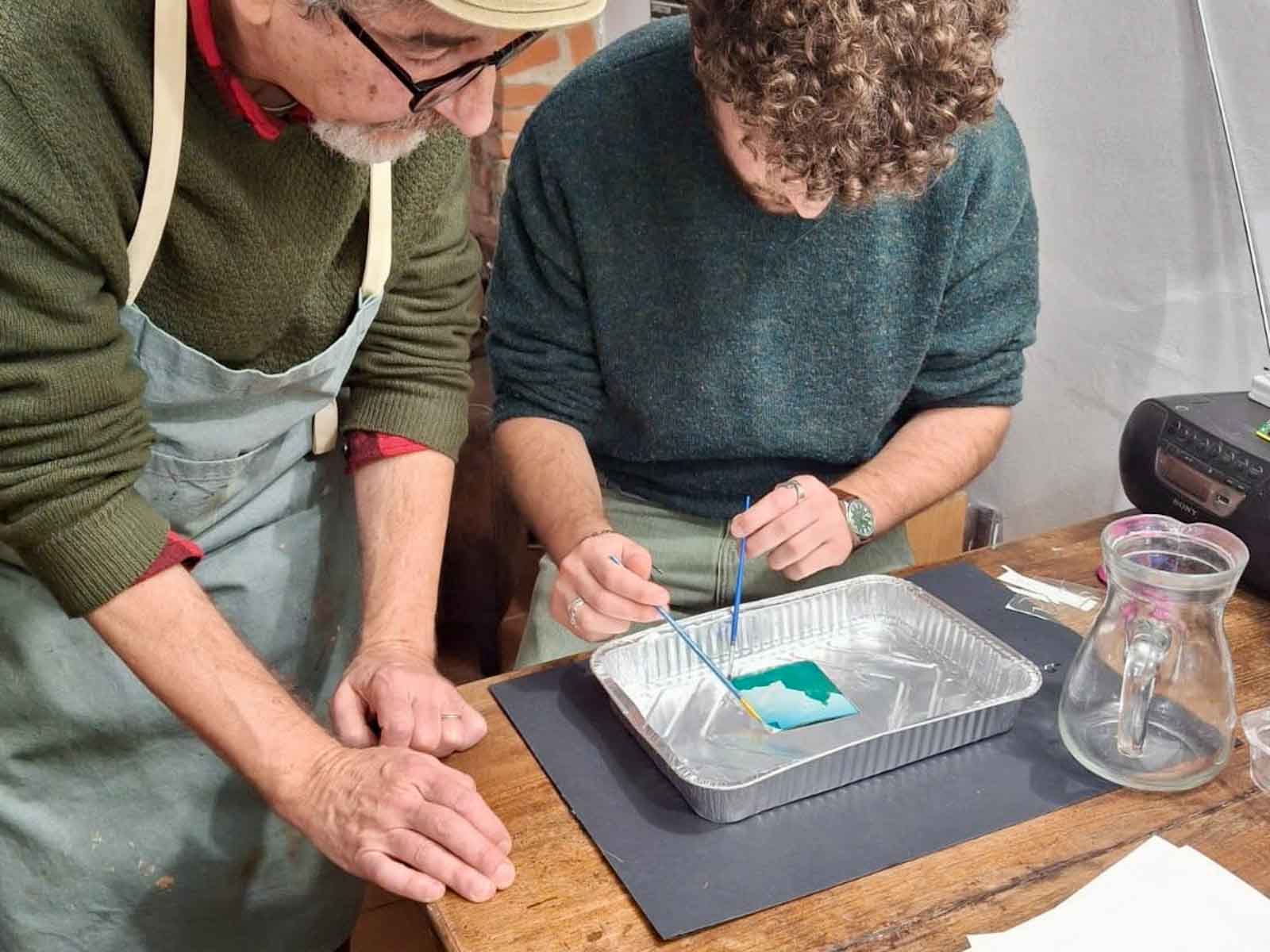 Leo guiding a participant through the Polaroid emulsion lift technique at Fatacadabra, Florence
