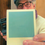 Leo holding a freshly ejected Polaroid film during the Polaroid workshop Florence at Fatacadabra