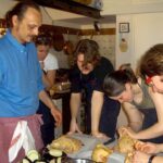 Chef and guests preparing meat together during a private tuscan farmhouse cooking class