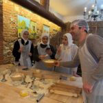 Private cooking class in Florence with chef guiding guests during a hands-on pasta lesson