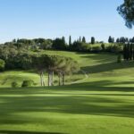 Panoramic view of a golf course and Tuscan hills in Chianti.