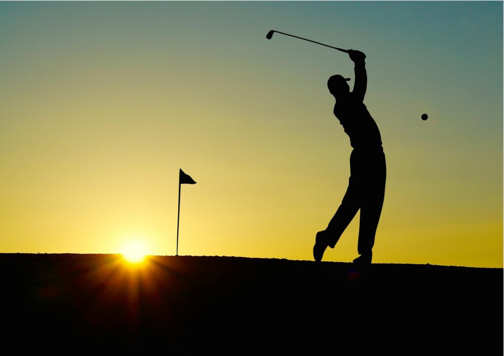 Golfer silhouette at sunset on a Tuscan course during a chianti golf lunch tour from Florence.