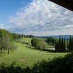 Tee box view of rolling fairway and green at a Chianti golf club.