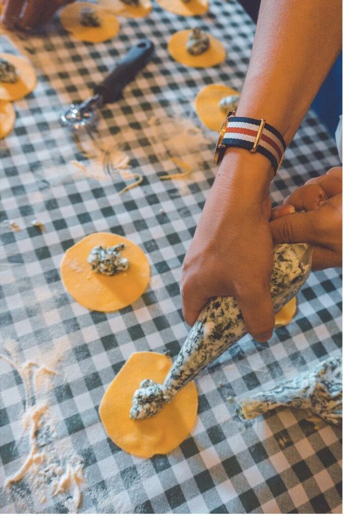 Guests filling handmade ravioli during the Chianti pasta making class