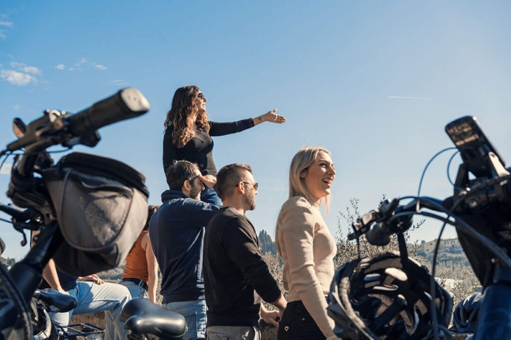 Guests stopping at a scenic hilltop viewpoint during a Florence e-bike tour