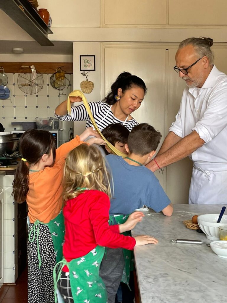 Family group with children during a private tuscan cooking class in florence with market shopping