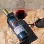 Glass of red wine and Fogliatonda bottle at Podere Ema in Chianti.