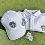 Golf Club Ugolino branded cap, polo shirt, and golf balls on green turf