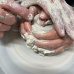Close-up of guided wheel technique in a Tuscan ceramics masterclass experience