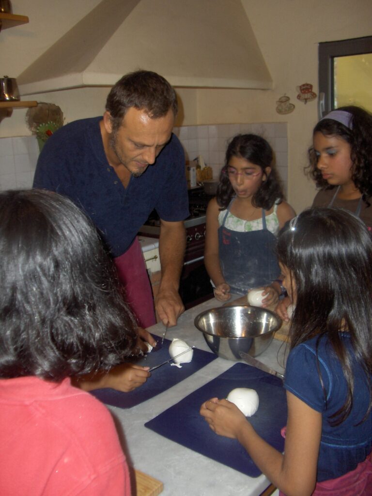 chef teaching children how to cut dough during a cooking class
