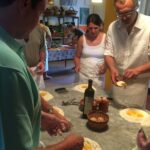 participants making fresh pasta dough with eggs during a cooking class