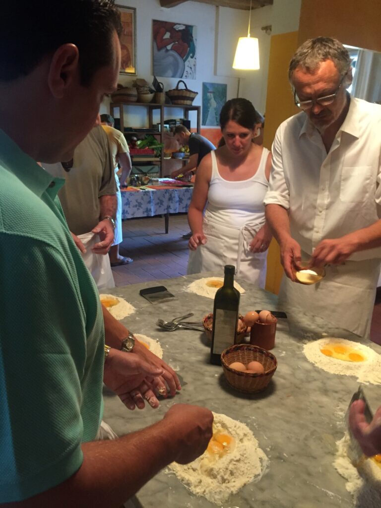 participants making fresh pasta dough with eggs during a cooking class