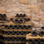 bottles aging in traditional Chianti wine cellar in Tuscany