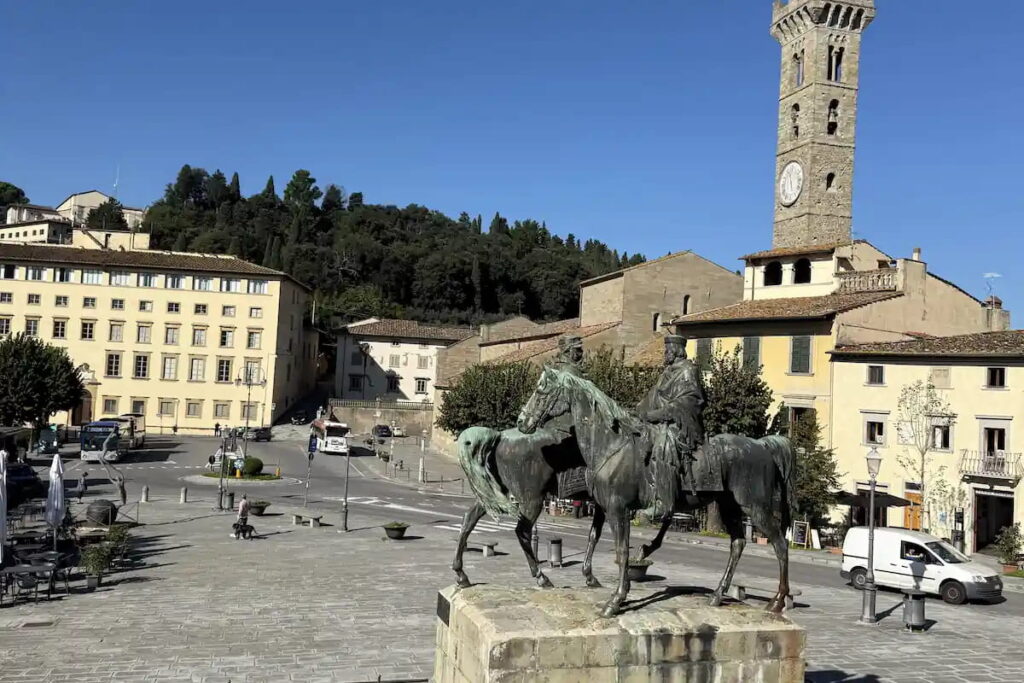 Piazza Mino da Fiesole with equestrian statue and medieval clock tower, stop on the e-bike tour from Florence