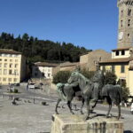 Piazza Mino da Fiesole with equestrian statue and medieval clock tower, stop on the e-bike tour from Florence