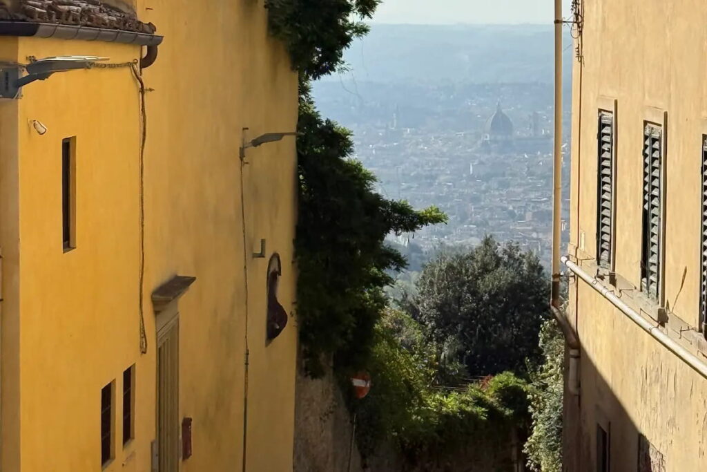 Florence Duomo seen through a narrow alley in Fiesole on the e-bike tour from Florence