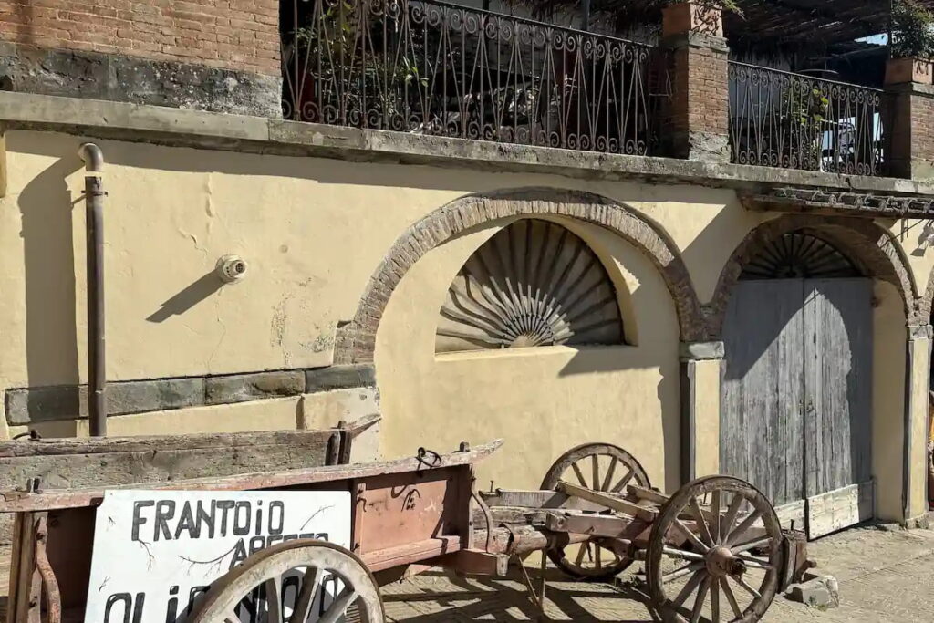 Old wooden cart with Frantoio sign at the olive oil farm near Fiesole, visited on the e-bike tour from Florence