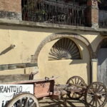 Old wooden cart with Frantoio sign at the olive oil farm near Fiesole, visited on the e-bike tour from Florence