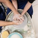 Guided wheel shaping during the pottery wheel workshop in Tuscany