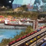 Miniature port with freight trains and cargo ships at HZERO Museum family tour Florence