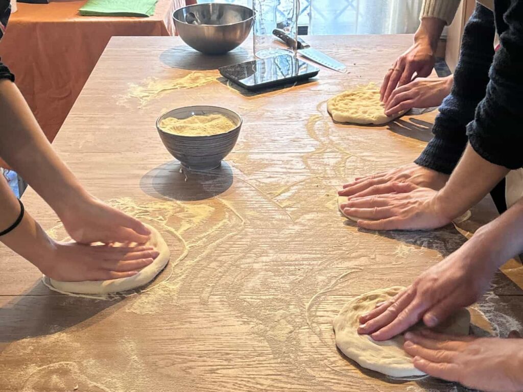 pizza making class Florence hands shaping dough on wooden table