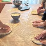 pizza making class Florence hands shaping dough on wooden table
